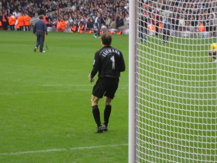 there is a male soccer player standing in the field