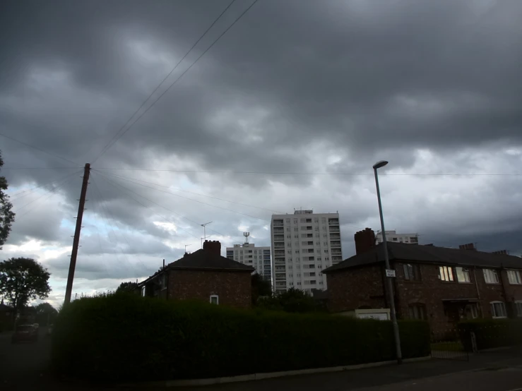 an empty road with tall buildings in the distance