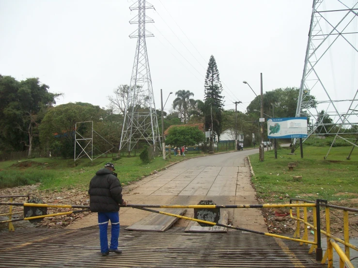 a man is looking at the area where power poles are in use