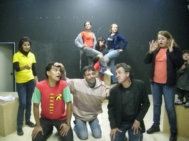 people sitting down and standing on a small platform in an auditorium