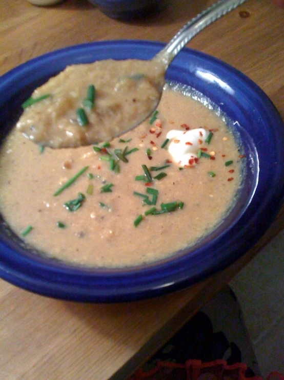 a spoon scooping from a bowl filled with soup