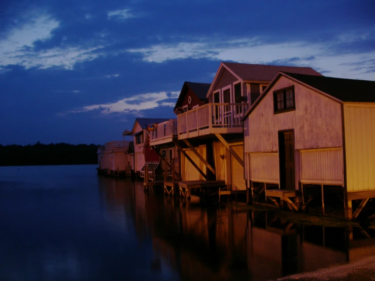 a row of homes sit along the water