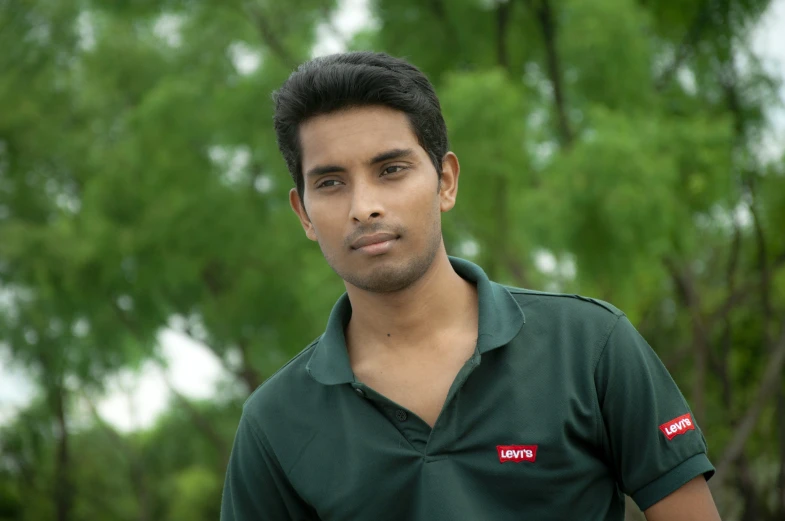 an indian male is looking directly into the camera