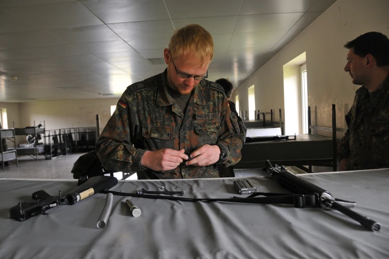 the man in the uniform is repairing an object