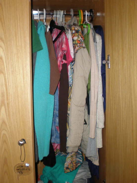 open closet with clothes on racks and hanging items