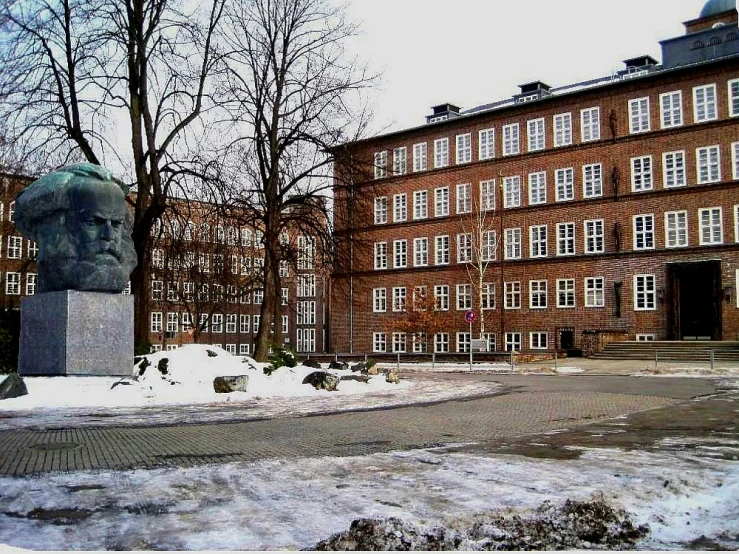 a building with many windows and two busturines in the middle