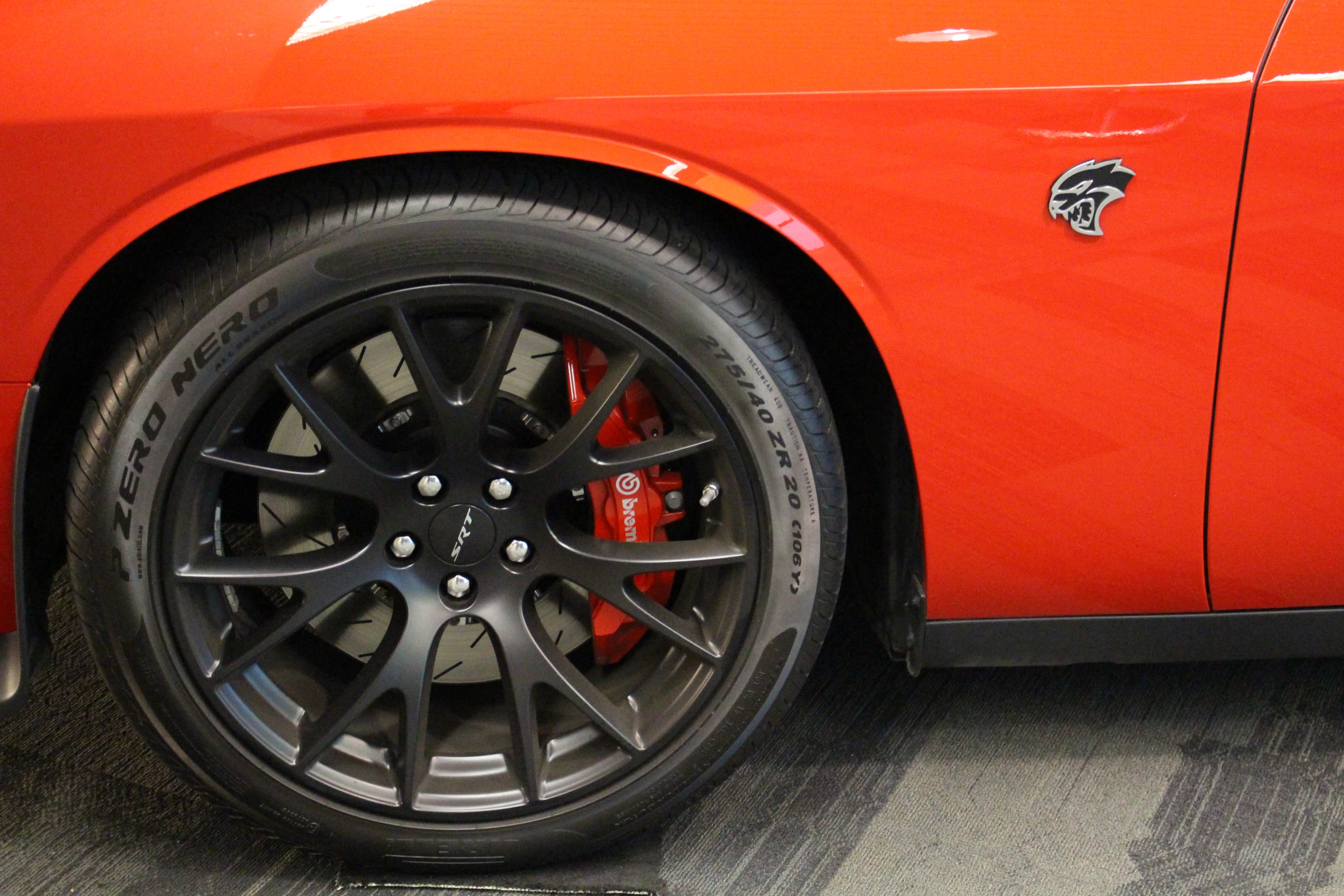 a closeup of the tires on the front of an orange vehicle