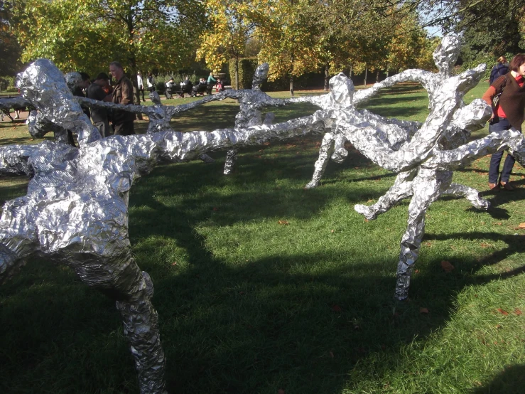 two people playing with some paper cut out of wood