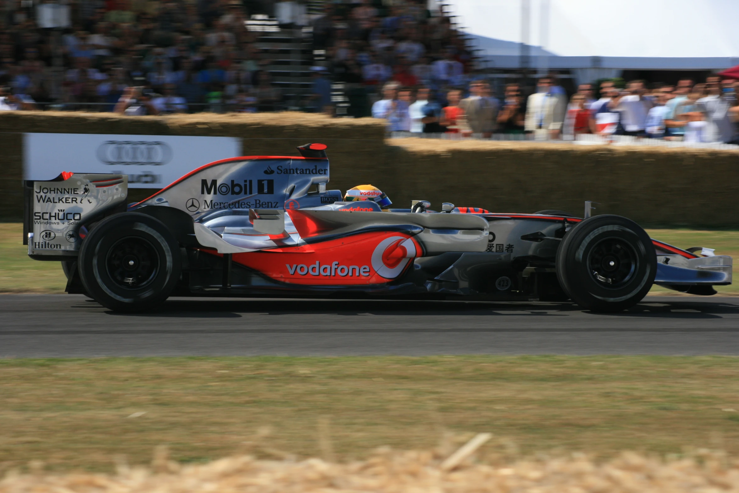 a red race car driving on a road