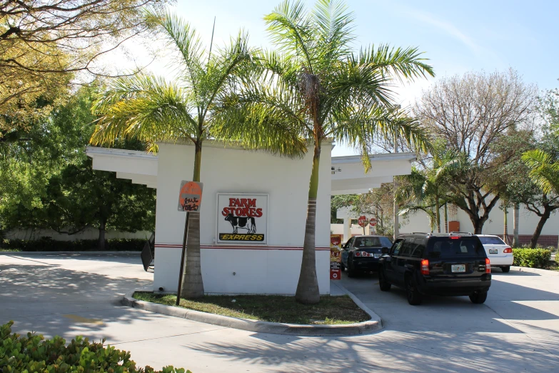 a couple of cars parked in front of a restaurant