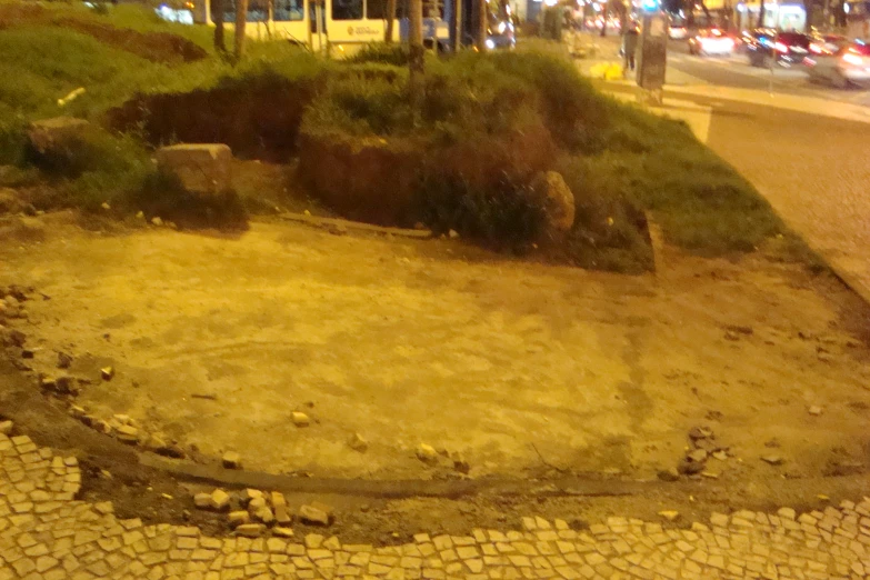 an elephant is walking down the street by a tree