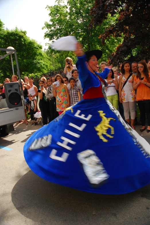 a woman is dancing with a frisbee in the park