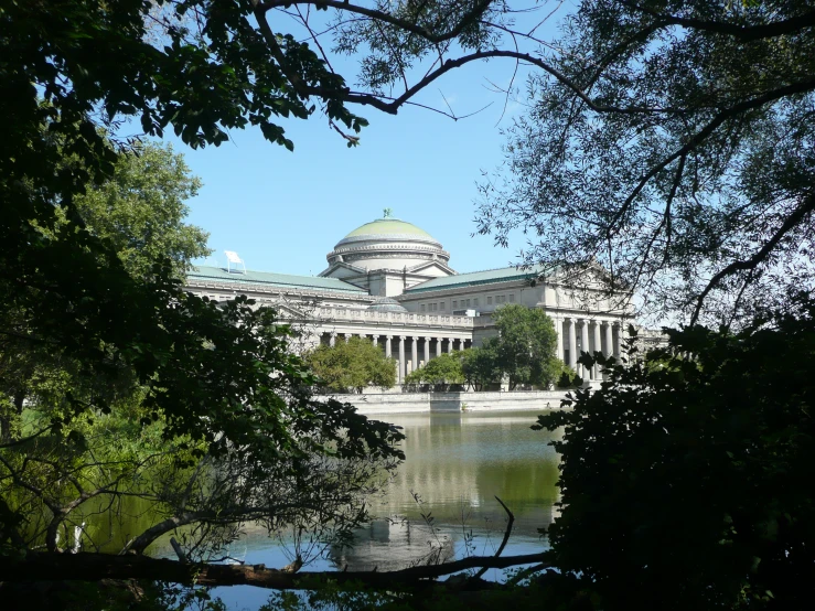 a lake with a building behind it in the distance