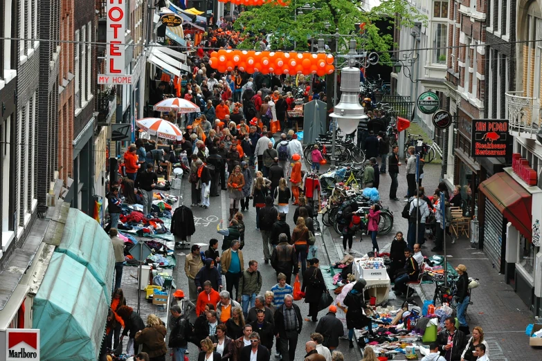 people are walking down the narrow city street