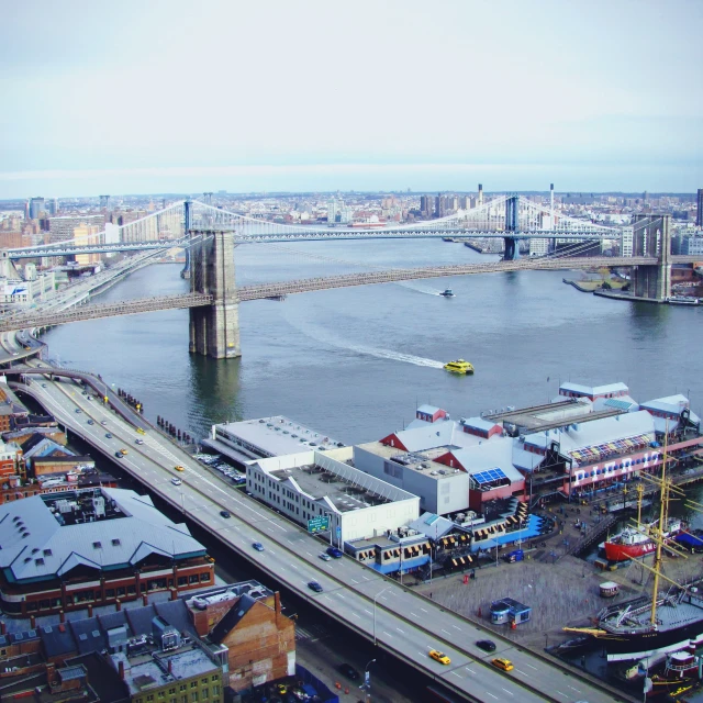 an overhead view of a bridge spanning the width of a river