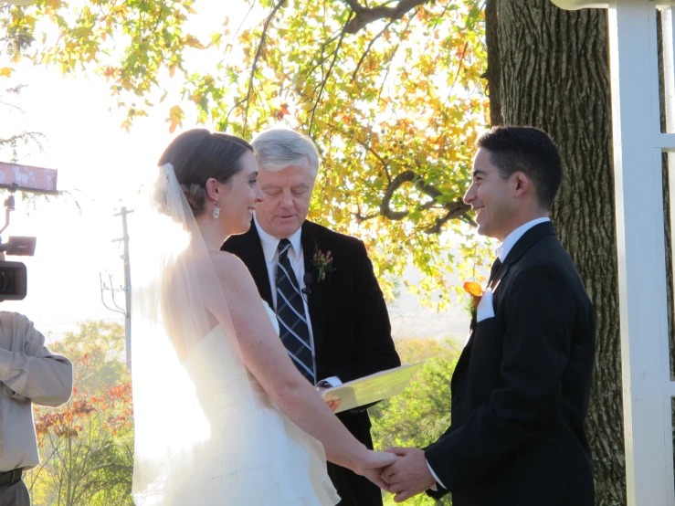 a man and woman standing next to each other holding hands