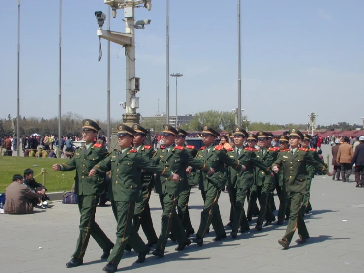 a group of men in uniform marching on street