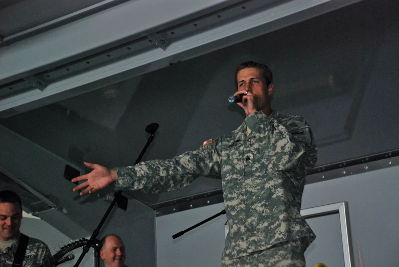 an image of a man singing into a microphone