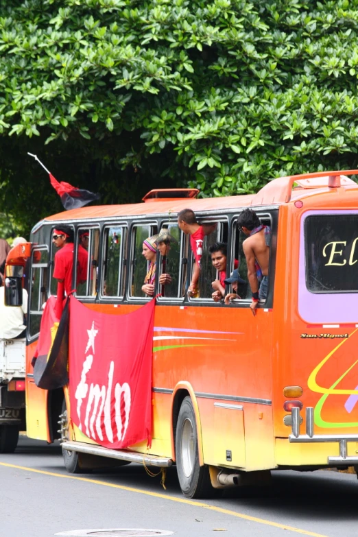 orange bus carrying passengers with people and an open door