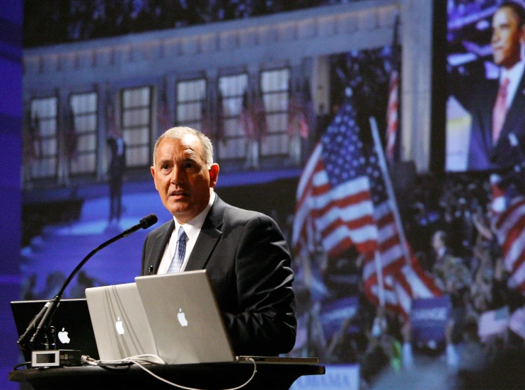 a man in a suit is at a podium