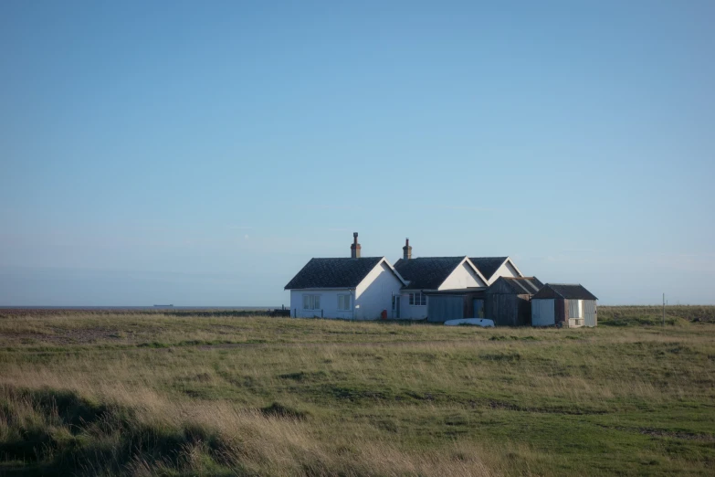 a large house sitting in a open field