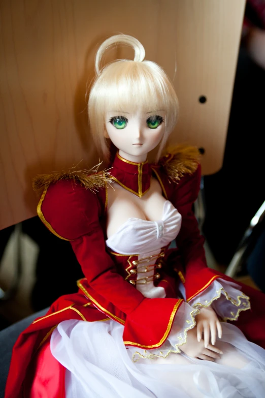 a close up of a doll dressed in red and white