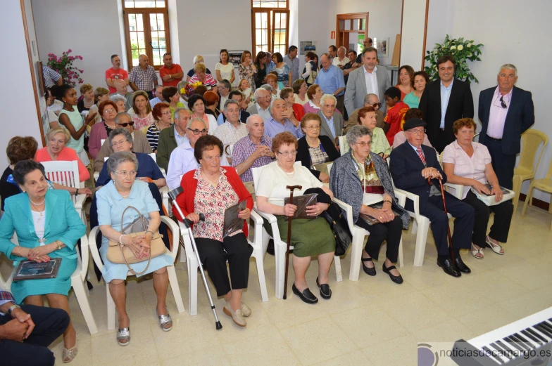 a large group of people are sitting and standing