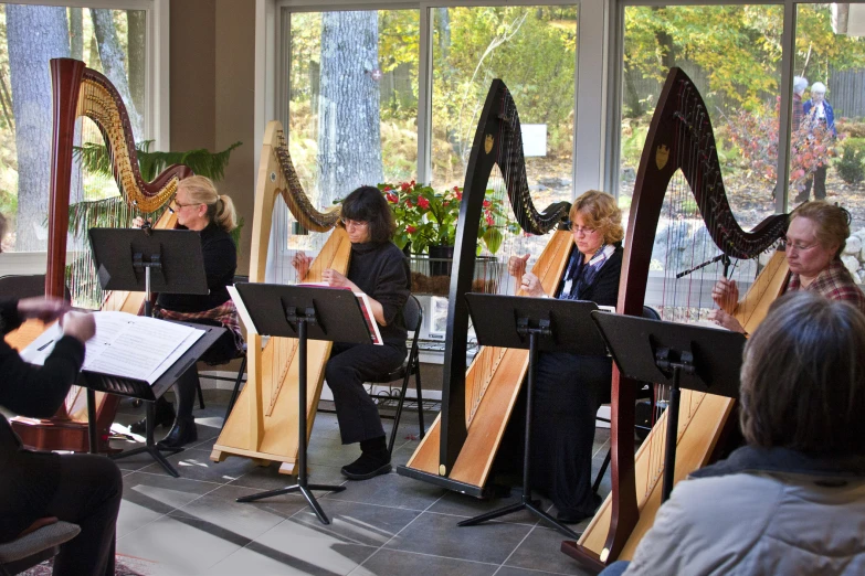 a group of people that are playing music in front of some windows