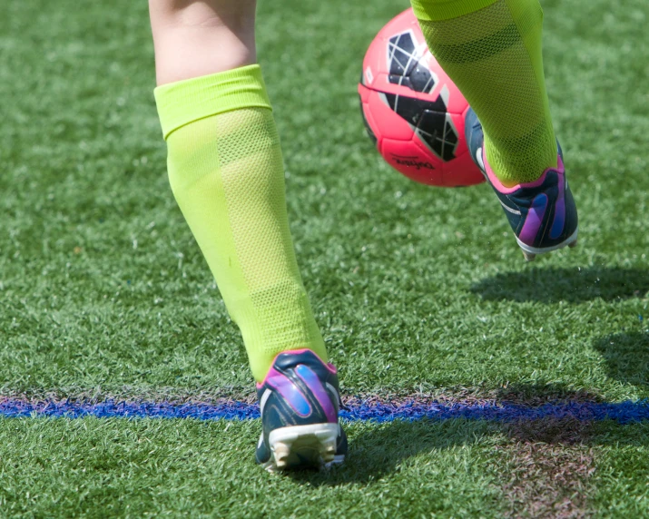 a girl wearing soccer gear running across the field