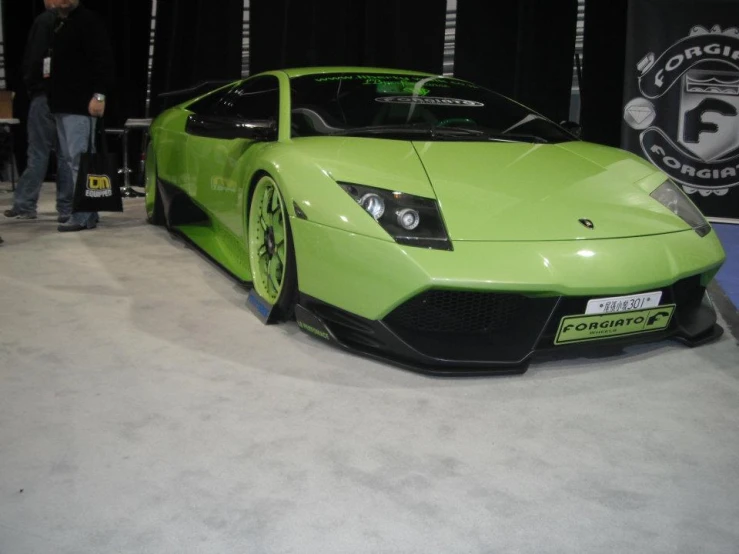 a bright green sports car in a showroom