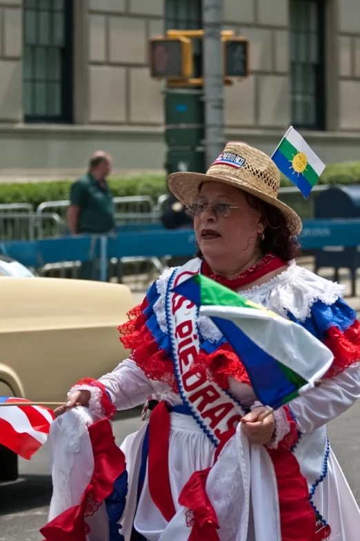 a woman wearing a flag - clad outfit in a street parade
