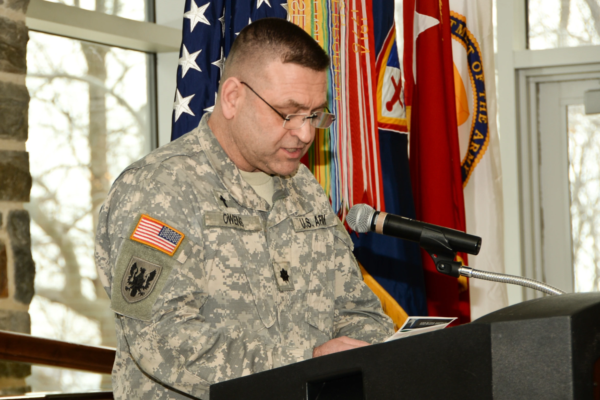 a man in uniform talking at a podium