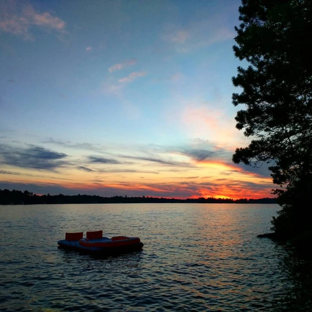 a boat out on the lake with trees