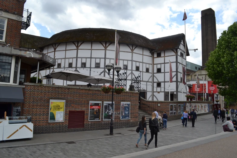 a building with several people walking around it