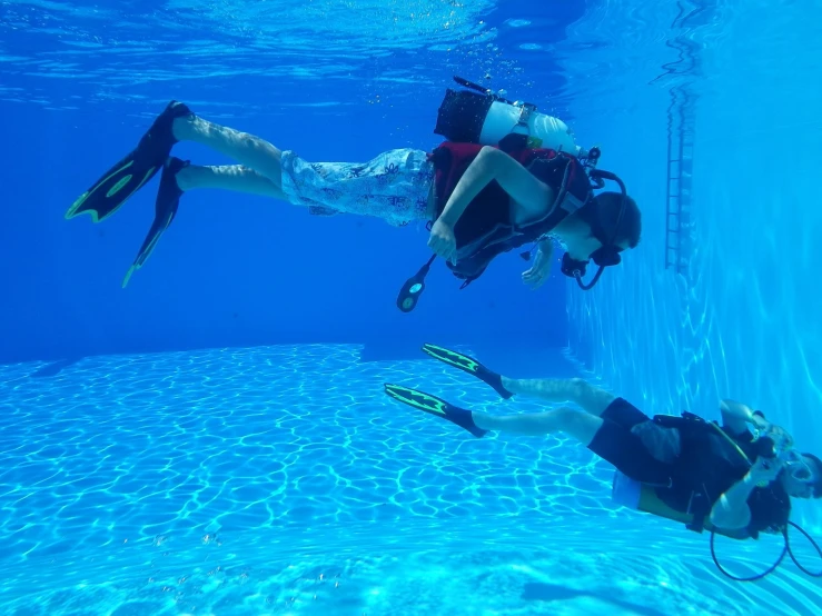 a couple of people that are diving in some water