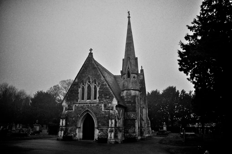 a church in the dark with the bell tower