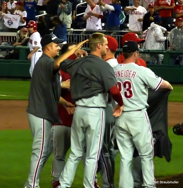 a group of baseball players stand in a circle together