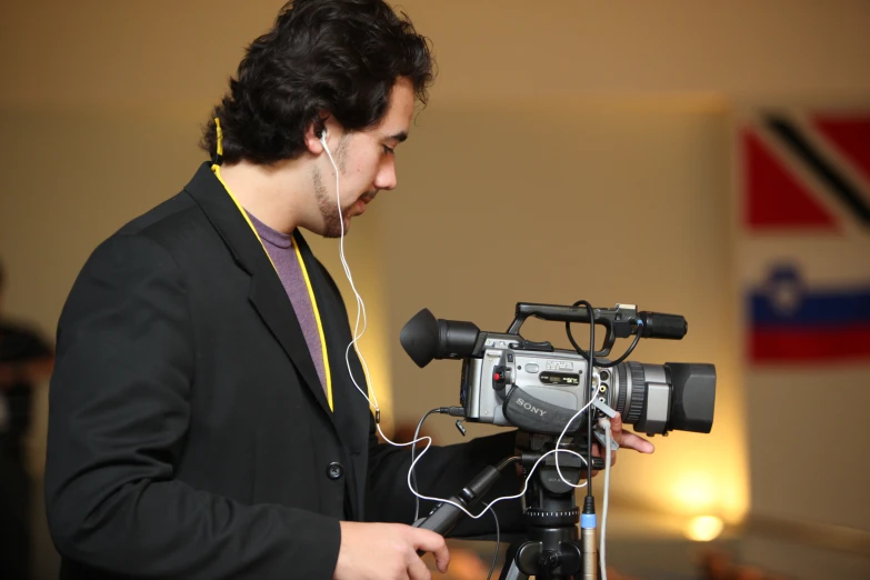 a person in a room with a camera and a microphone
