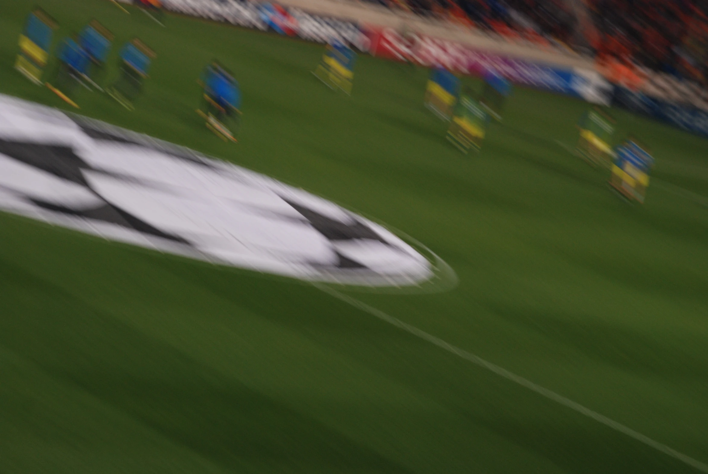 a blurry po of the black and white checkered flag on a green field