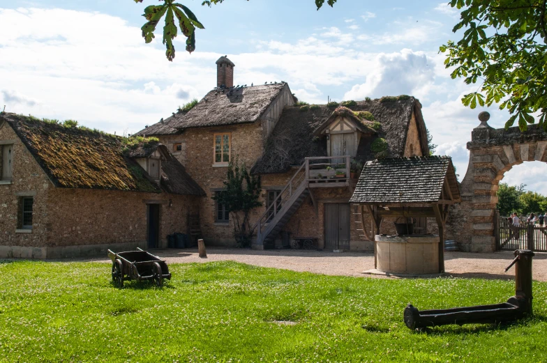 an old european house has grass roof and large windows