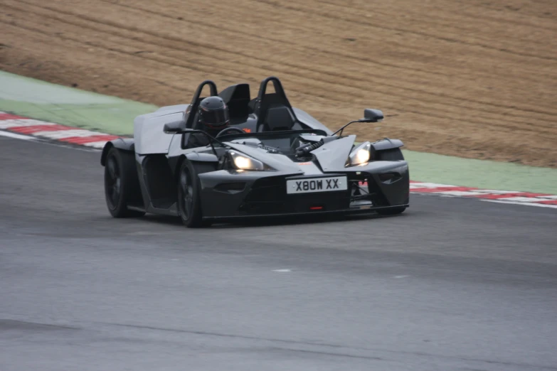 a close up of a race car driving down the race track