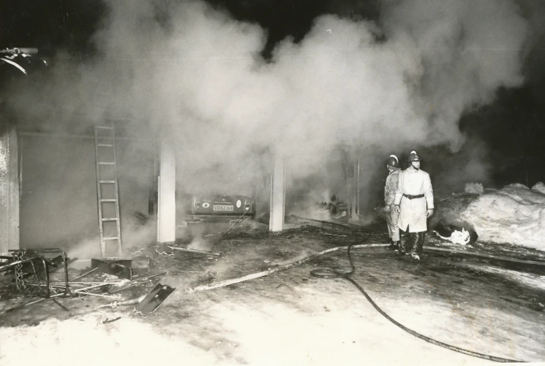 a person standing in front of a burning house