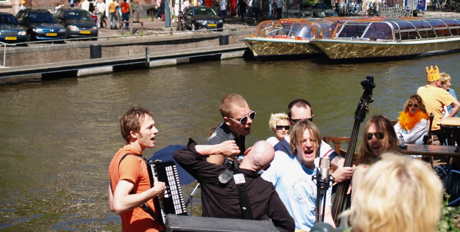 the group of people are sitting by the water