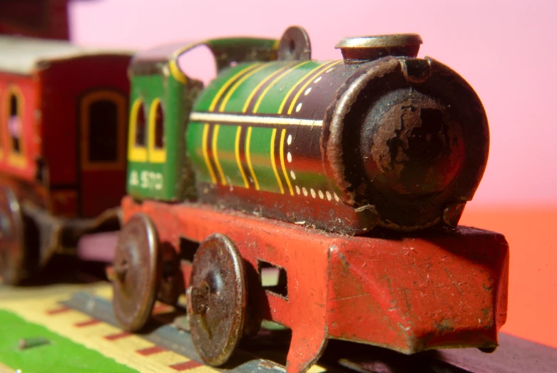 small, colorful toy train on small wooden tracks