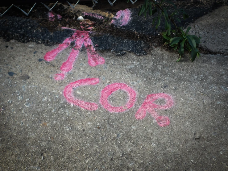 a pink piece of string next to a sign that says go