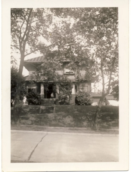 a large house surrounded by trees with a fence