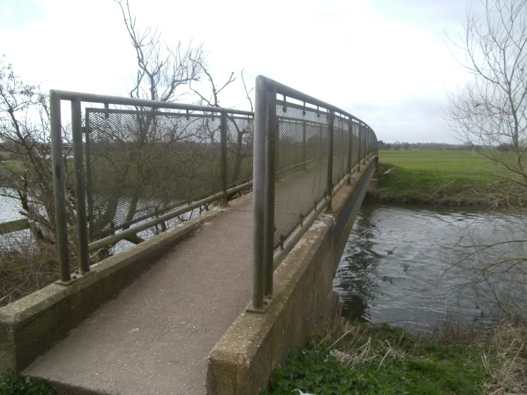 a metal fence is on the foot bridge