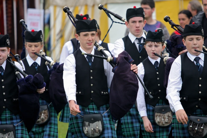 a band of bagpipe players standing on each side of a row