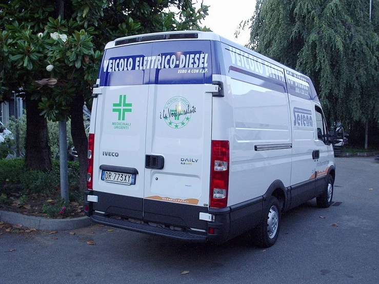 a van parked in a parking space with trees around