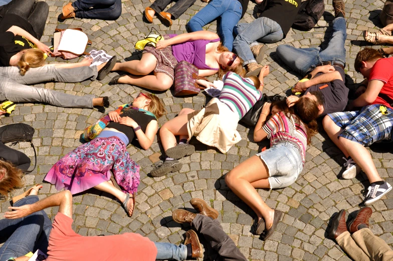 a group of people relaxing on cobblestone walkway